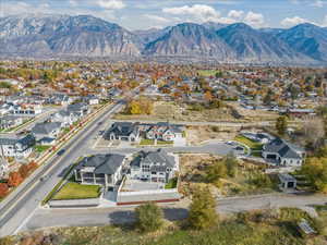 Birds eye view of property with a mountain view and a residential view