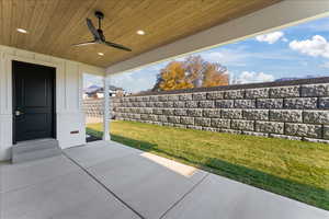 View of patio with fence and ceiling fan