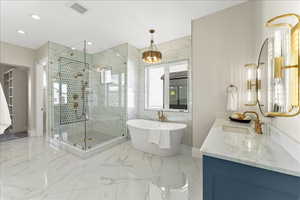 Bathroom with a freestanding bath, visible vents, marble finish floor, a shower stall, and vanity