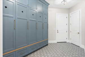 Mudroom featuring tile patterned floors and baseboards
