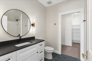 Full bath with tile patterned flooring, toilet, vanity, and visible vents