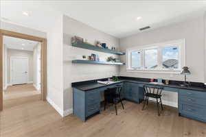 Office area featuring recessed lighting, built in study area, light wood-type flooring, and visible vents