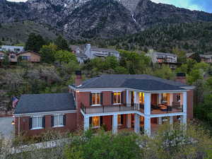 View of front of house with a mountain view, brick siding, and a chimney