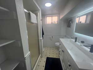Bathroom with a shower stall, vanity, tile patterned floors, new paint and vanity w/ faucets