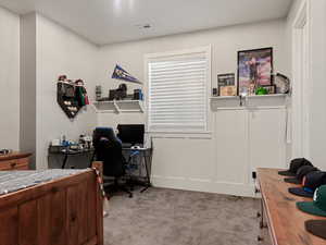 Bedroom with visible vents and light colored carpet