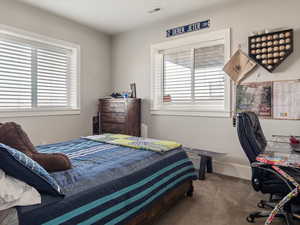 Carpeted bedroom with visible vents