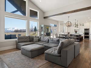 Living area featuring a mountain view, recessed lighting, a notable chandelier, and dark wood-type flooring