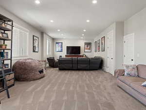 Living area featuring recessed lighting and light colored carpet
