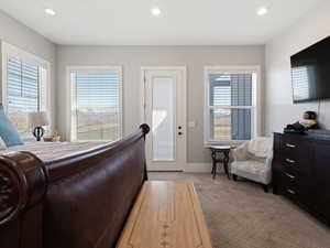 Bedroom featuring multiple windows, recessed lighting, baseboards, and light carpet