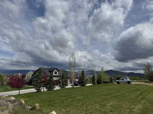 View of community with a lawn and a mountain view