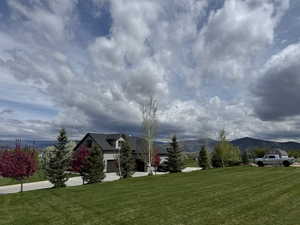 View of grassy yard with a mountain view
