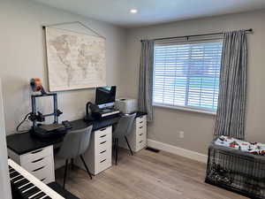 Office with baseboards, recessed lighting, visible vents, and light wood-style flooring