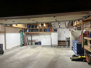 Garage featuring refrigerator and a workshop area