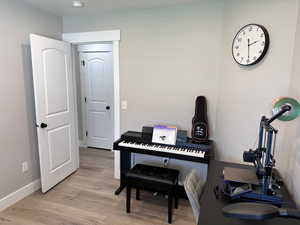 Sitting room featuring light wood-style floors and baseboards