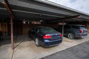 Covered parking lot featuring fence