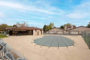 Community pool featuring fence and an outbuilding