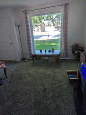 Rec room featuring healthy amount of natural light, carpet flooring, and a textured ceiling