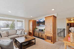 Living area featuring recessed lighting and a textured ceiling