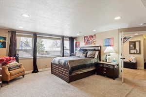 Bedroom featuring baseboards, recessed lighting, a textured ceiling, and light colored carpet