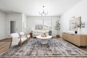 Living room featuring wood finished floors, a chandelier.