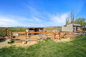 View of yard featuring an outdoor structure and an exterior structure