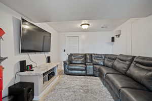 Living room with visible vents, light wood-type flooring, and baseboards