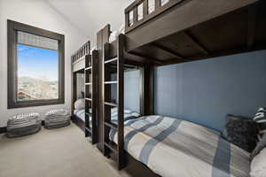 Bedroom featuring carpet floors and lofted ceiling