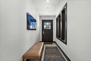 Doorway to outside with baseboards