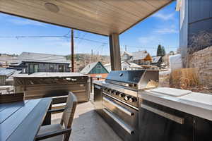 View of patio / terrace featuring grilling area, a hot tub, and a residential view