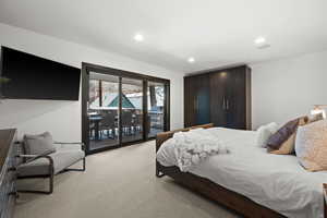 Bedroom with light carpet, access to outside, and recessed lighting