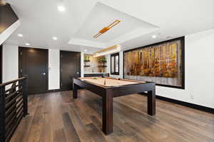 Game room with recessed lighting, billiards, a tray ceiling, dark wood-type flooring, and baseboards
