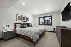 Bedroom with light carpet, baseboards, visible vents, and recessed lighting