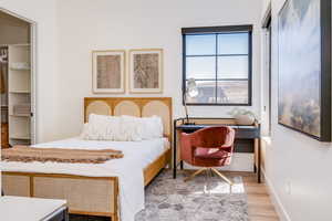 Bedroom with baseboards and light wood-type flooring