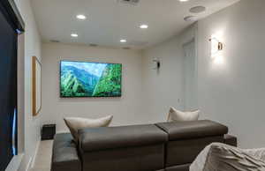 Carpeted cinema room with visible vents, recessed lighting, and baseboards