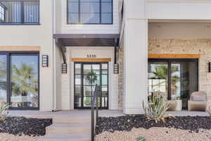 Entrance to property featuring a porch and stucco siding