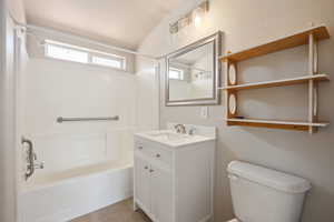 Bathroom featuring toilet, tile patterned flooring, washtub / shower combination, and vanity