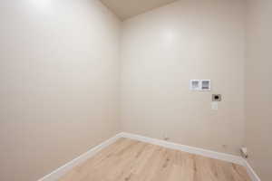 Washroom with electric dryer hookup, hookup for a washing machine, baseboards, and hookup for a gas dryer