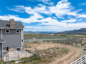 View of yard with fence and a mountain view