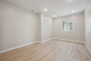 Spare room with recessed lighting, visible vents, baseboards, and light wood-type flooring
