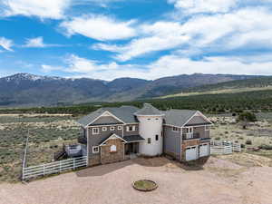Exterior space featuring fence, driveway, a mountain view, and an attached garage