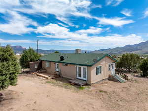 Back of house with french doors and a deck with mountain view