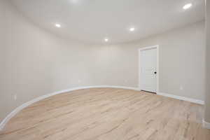 Unfurnished room with light wood-style floors, recessed lighting, and baseboards