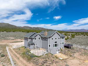 Exterior space with a mountain view, a chimney, and fence