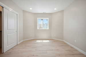 Interior space featuring baseboards, visible vents, light wood finished floors, and recessed lighting