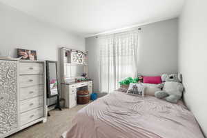 Bedroom featuring light colored carpet