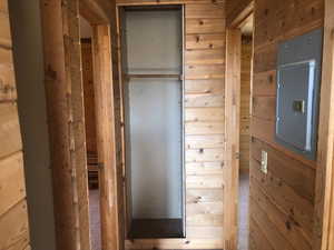 Corridor featuring wood walls