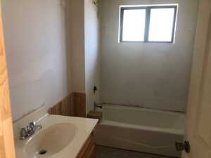 Bathroom with shower / bathing tub combination and vanity