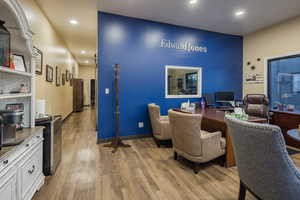 Office area featuring light wood finished floors and recessed lighting