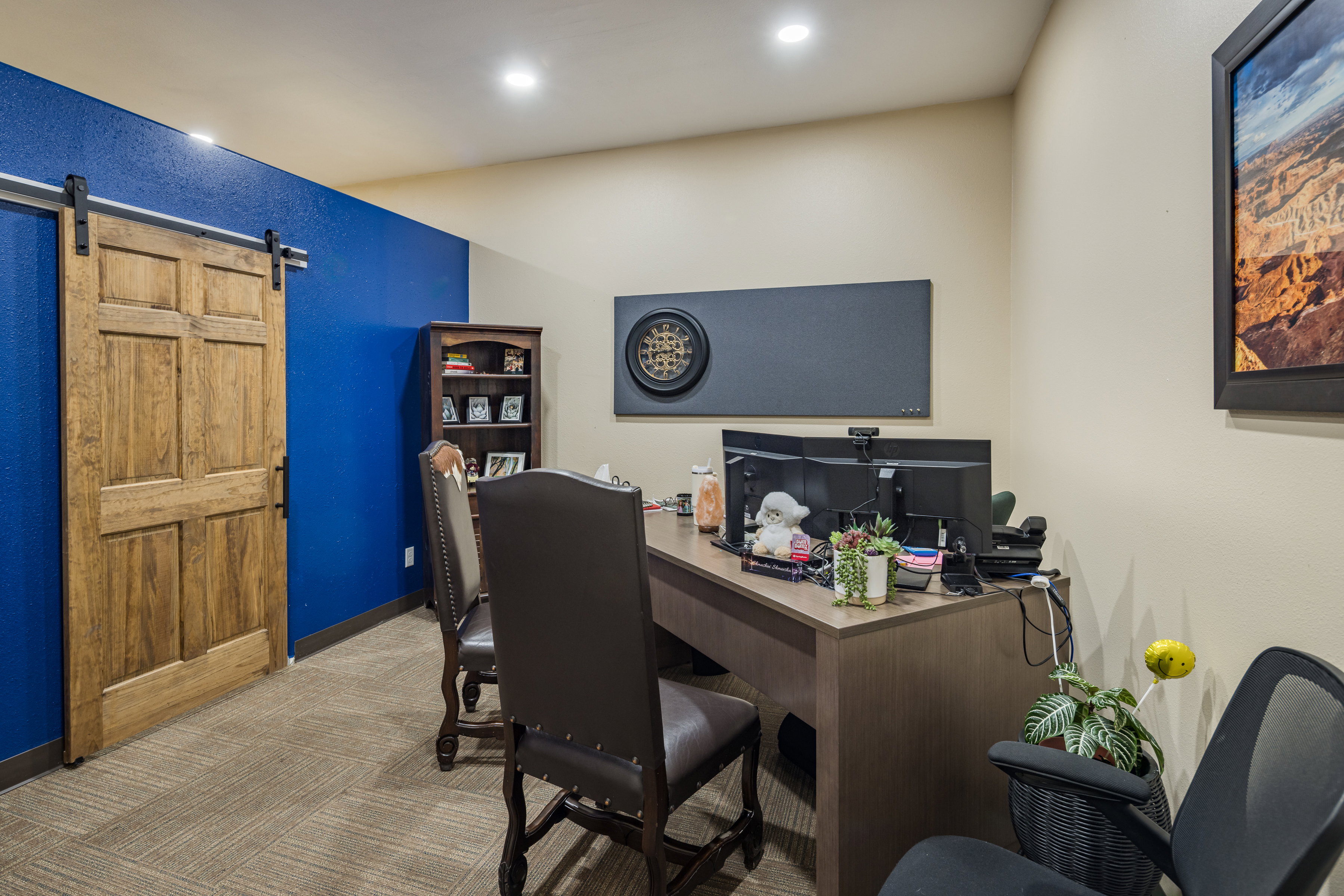 Carpeted office space with a barn door, baseboards, and recessed lighting
