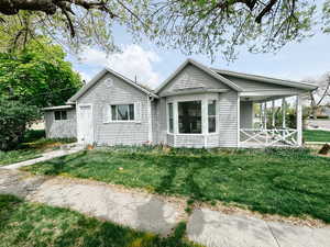 Ranch-style house with a porch and a front lawn